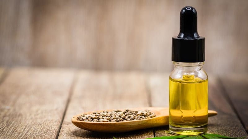 CBD oil and hemp seed on a wooden table