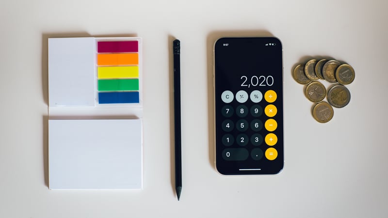 office supplies and coins on white table